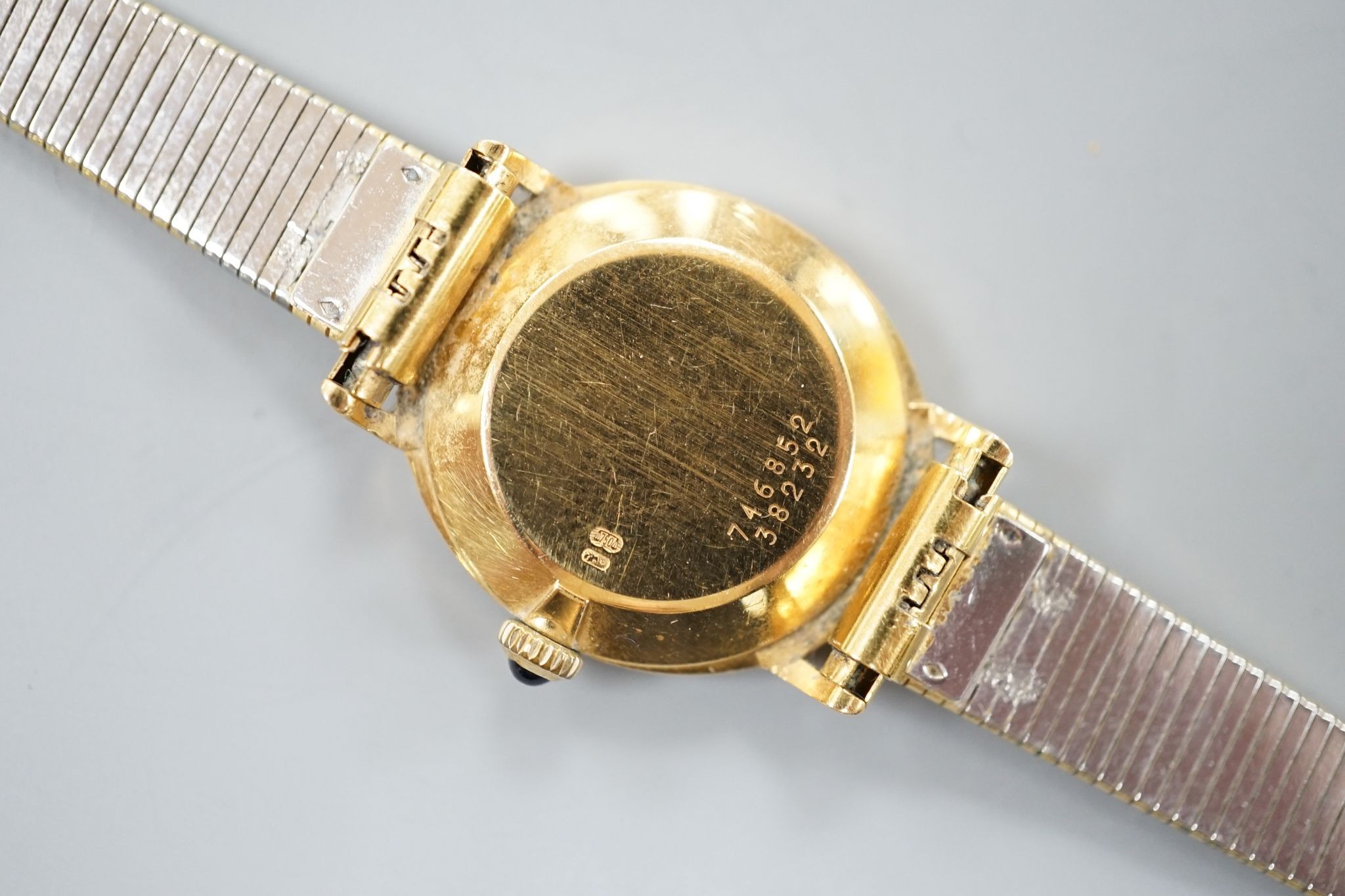 A lady's 18ct gold Baume & Mercier manual wind dress wrist watch, on an associated gold plated bracelet, case diameter 23mm, gross weight 28.3 grams.